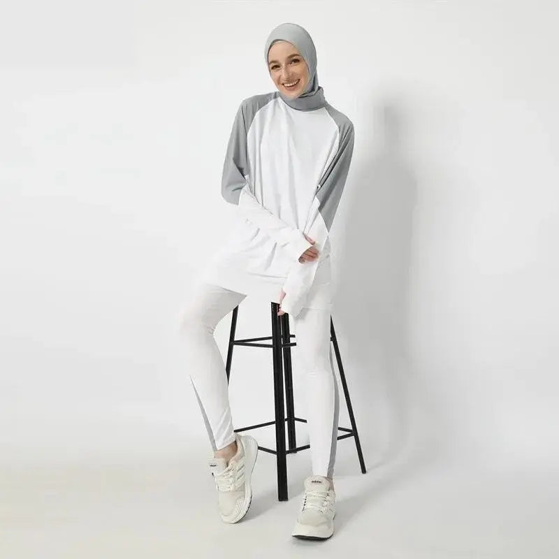 white modest jogger set model sitting on a chair